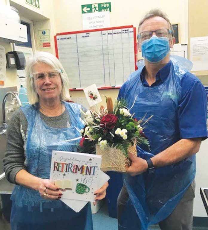 Linda Rogers is presented with a bouquet of flowers by Marcus Johnstone.