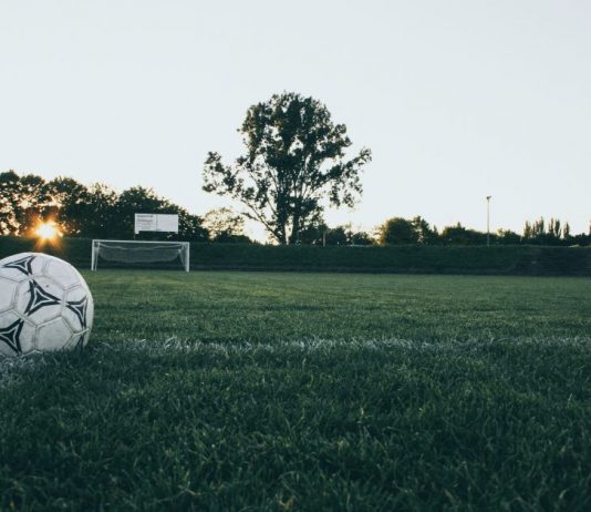 Football chiefs call full time on season for lower leagues A close up shot of a football in front of a goal.