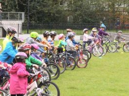Rising accident rate sees kids given bike safety courses Children lined up on their bikes in a field.