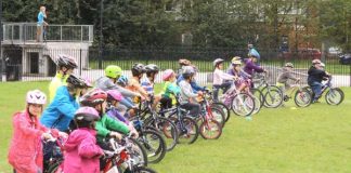 Rising accident rate sees kids given bike safety courses Children lined up on their bikes in a field.