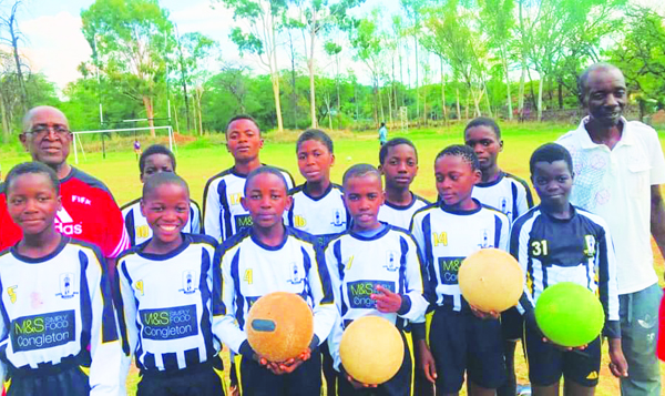 Young players in Zimbabwe show off their new kits once worn on the football pitches of Congleton.