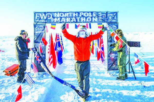 A runner passes the finish line at a previous North Pole Marathon.