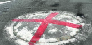 Red cross keep drivers ‘alert’ Mini roundabout cross.